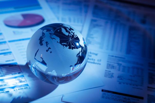 glass-globe-with-financial-reports-graphs-toned-image