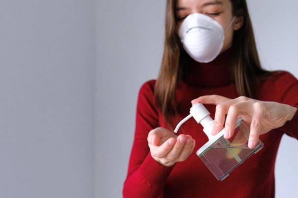 woman-applying-hand-sanitizer-3987146